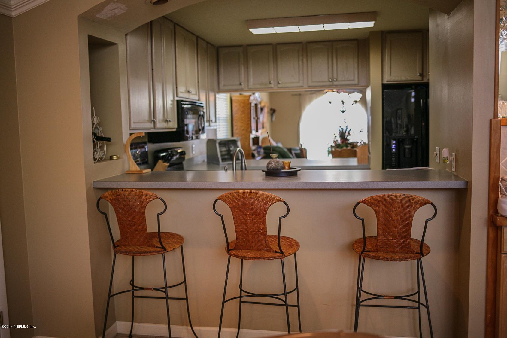 3967 Eunice Road Jacksonville, FL 32250 - Photo 7 of 28 a kitchen with stainless steel appliances a sink and cabinets