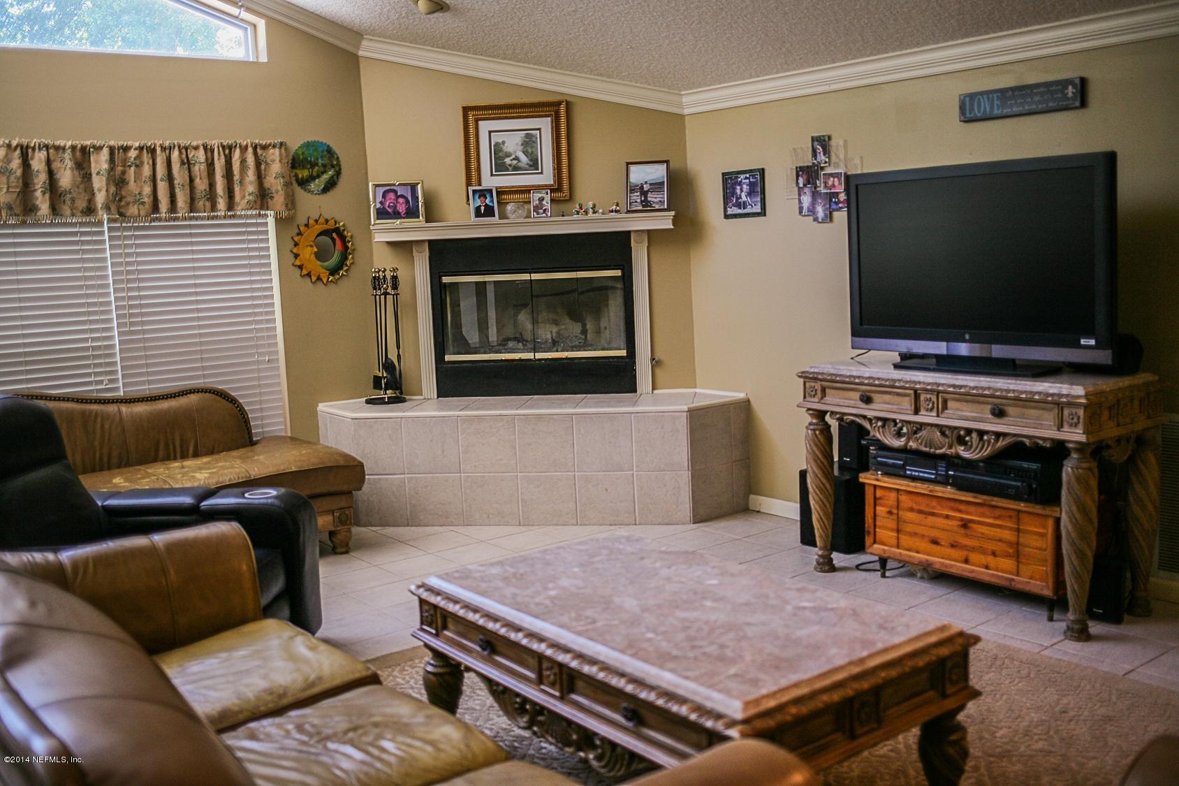 3967 Eunice Road Jacksonville, FL 32250 - Photo 8 of 28 a living room with furniture and a flat screen tv