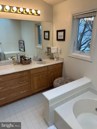 a bathroom with a sink mirror and window