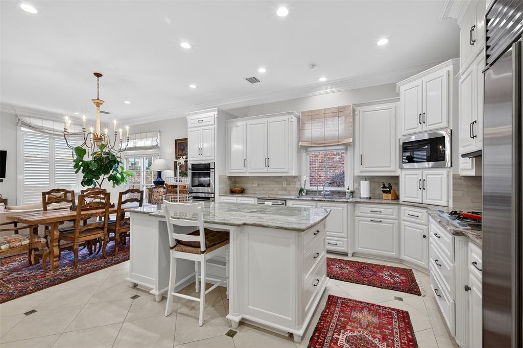7717 Creswell Road, Unit 48 Shreveport, LA 71106 - Photo 10 of 37 a kitchen with white cabinets and chairs