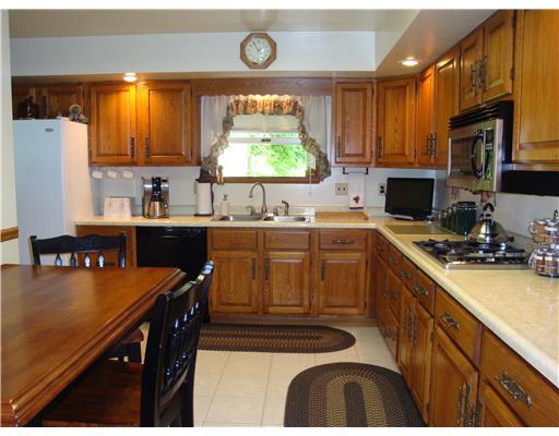 115 Township Line Road Butler, PA 16002 - Photo 10 of 18 Kitchen. New ceramic tile throughout the eat in kitchen and dining room. Solid wood kitchen cabinets.