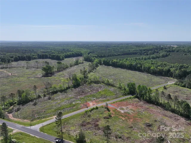 a view of a house with swimming pool and a yard