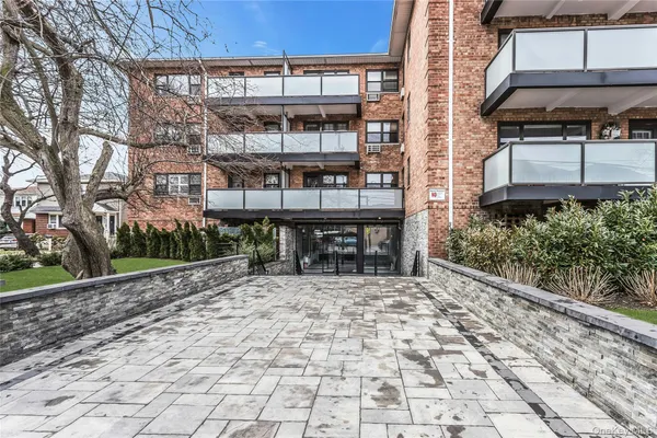 a view of a chairs and table in the backyard