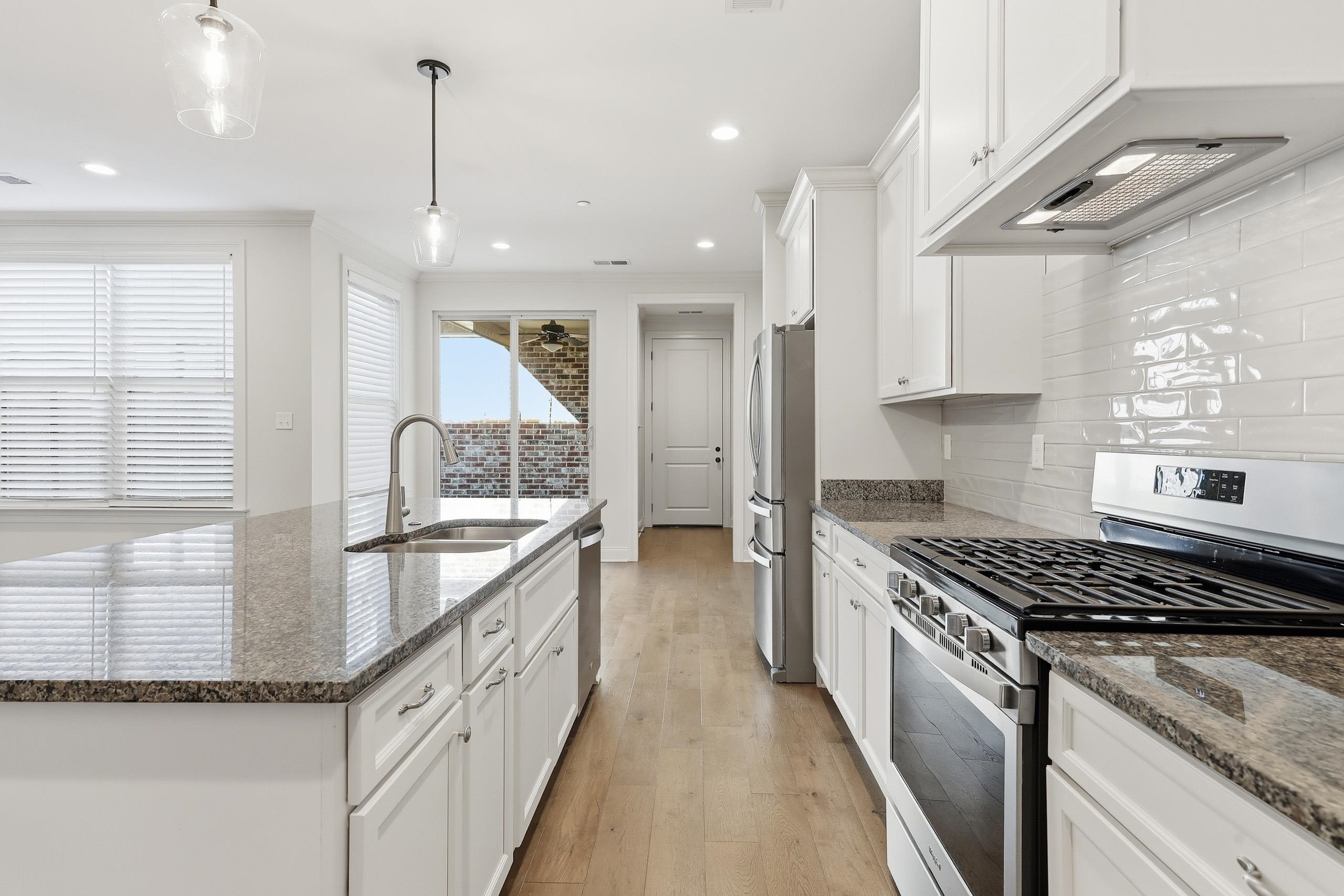 897 Ufton Alley Collierville, TN 38017 - Photo 14 of 32 a kitchen with stainless steel appliances granite countertop a stove and a sink