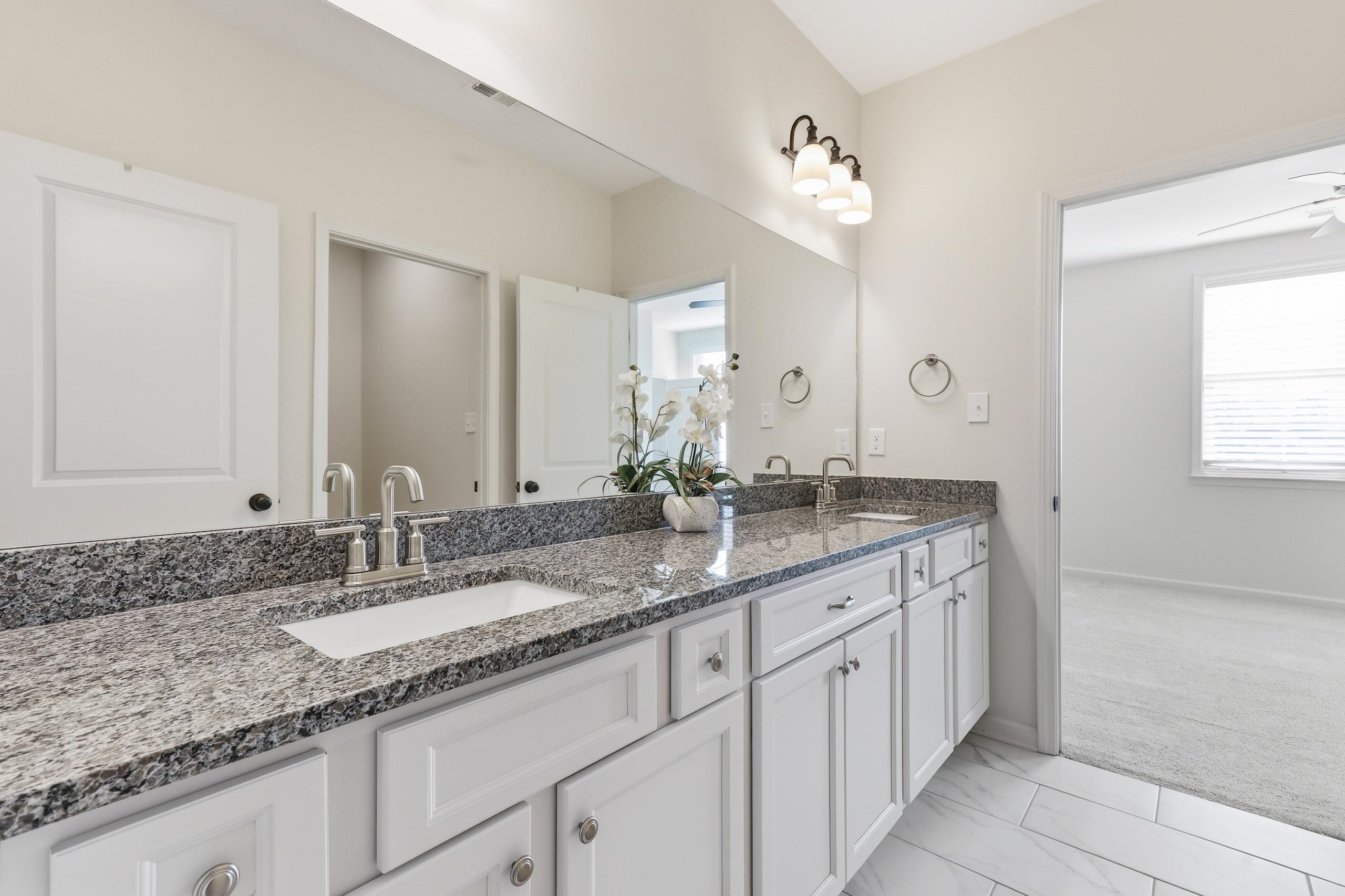 897 Ufton Alley Collierville, TN 38017 - Photo 29 of 32 a bathroom with a granite countertop double sink and a mirror