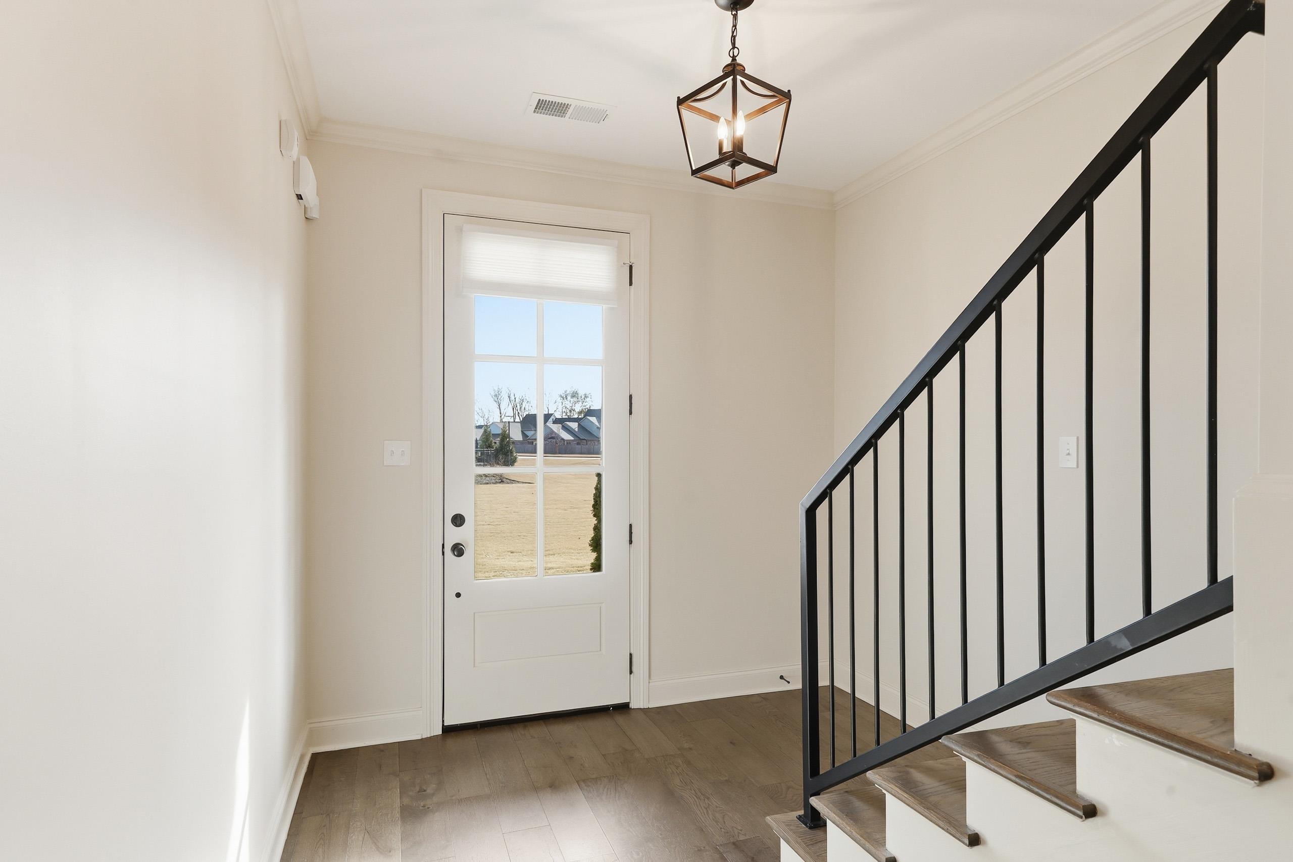 897 Ufton Alley Collierville, TN 38017 - Photo 6 of 32 a view of a hallway with wooden floor and staircase