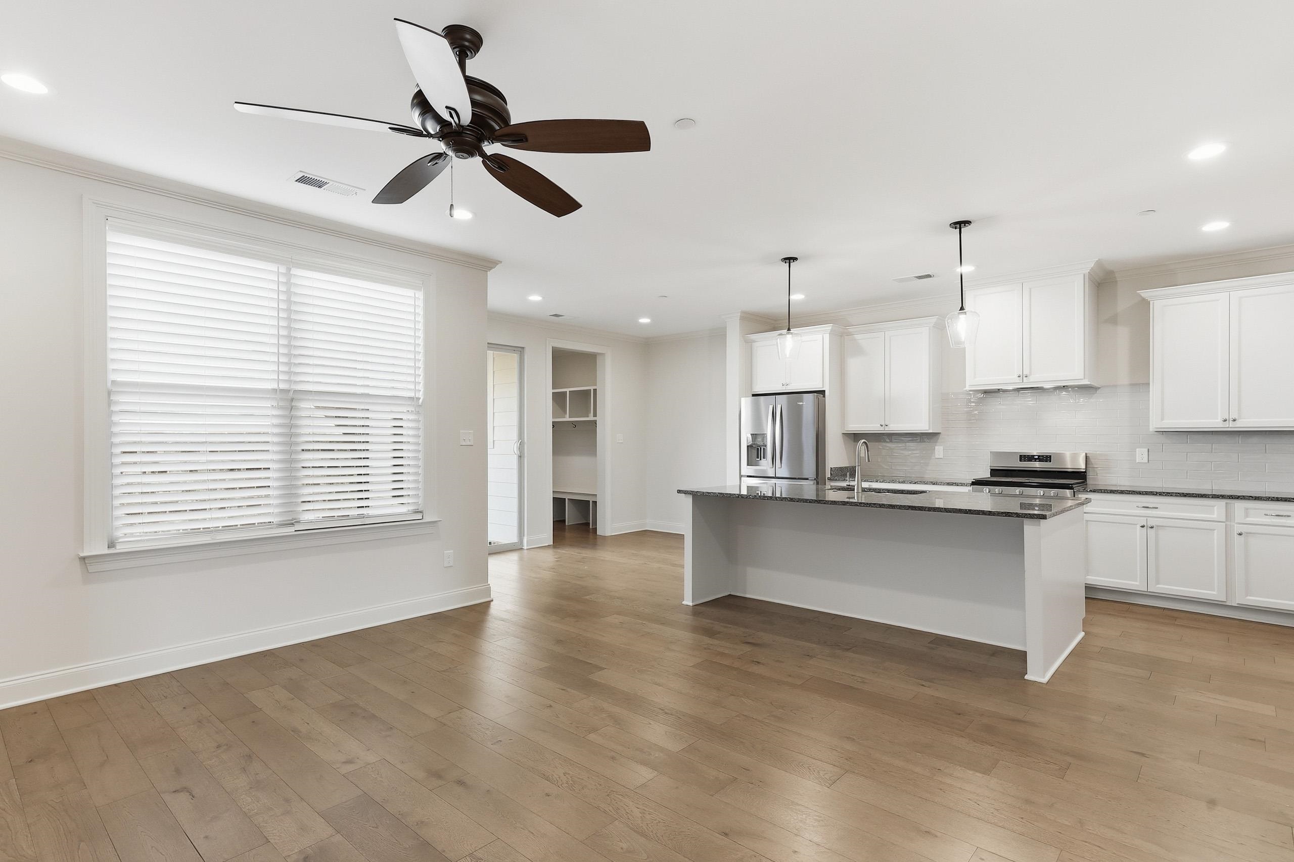 897 Ufton Alley Collierville, TN 38017 - Photo 7 of 32 a large kitchen with cabinets a sink a window and stainless steel appliances