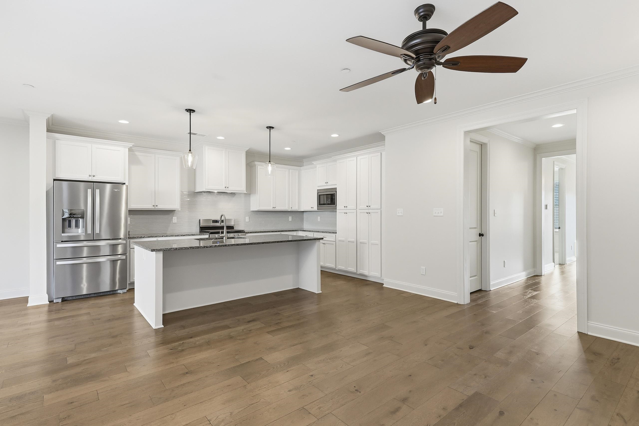 897 Ufton Alley Collierville, TN 38017 - Photo 9 of 32 a large kitchen with stainless steel appliances kitchen island a refrigerator and a stove top oven
