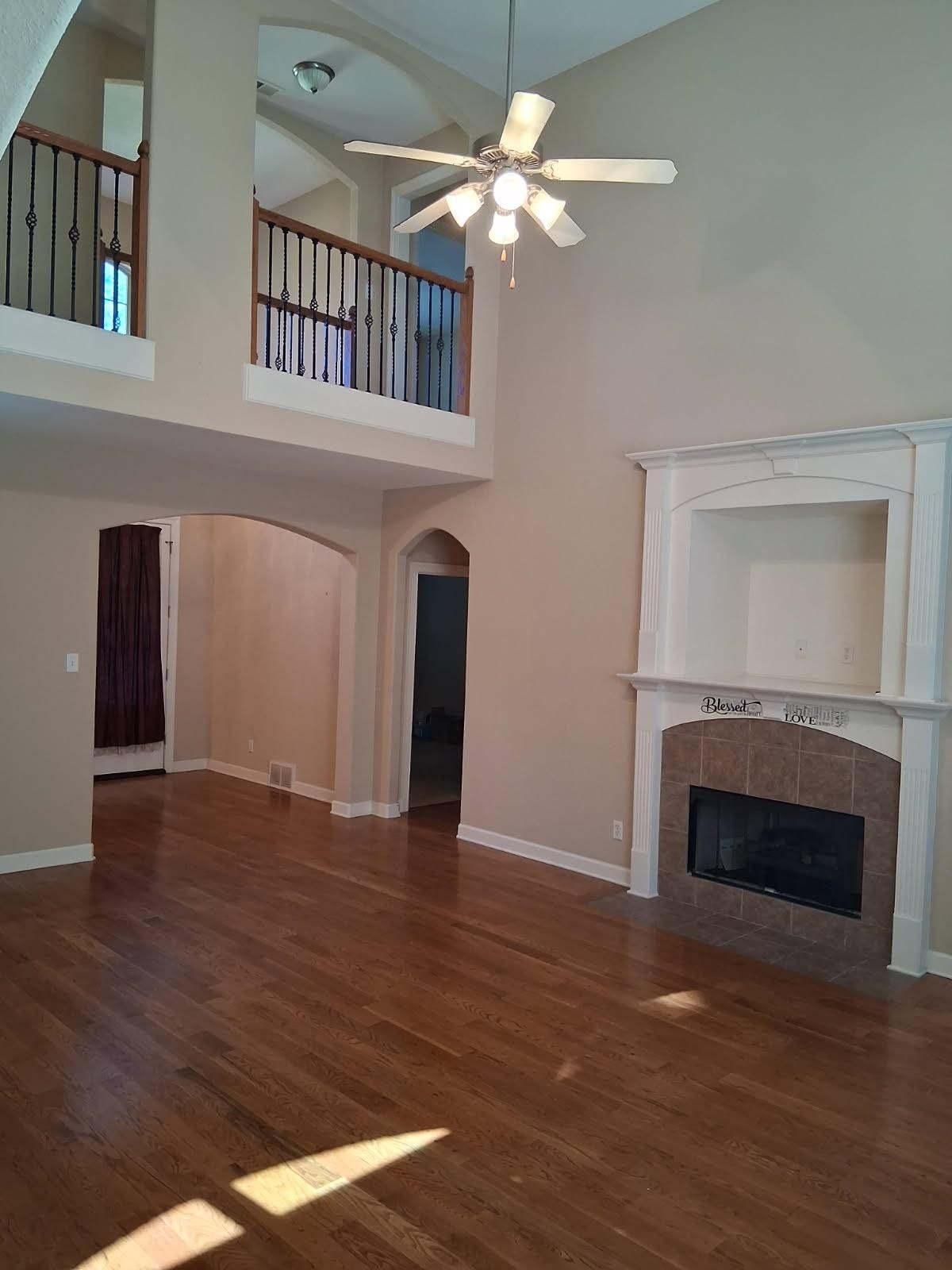 10481 Mabry Mill Road Cordova, TN 38016 - Photo 3 of 32 a view of an empty room with wooden floor fireplace and a window