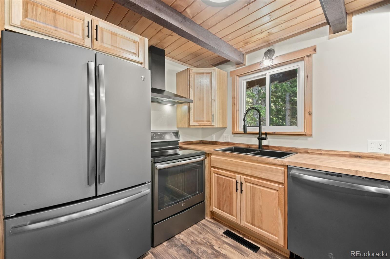 827 Mine Road Idaho Springs, CO 80452 - Photo 11 of 30 a kitchen with stainless steel appliances granite countertop a refrigerator sink and stove