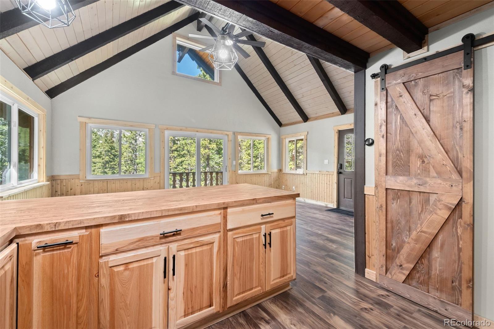 827 Mine Road Idaho Springs, CO 80452 - Photo 12 of 30 a kitchen with a stove a refrigerator and wooden cabinets