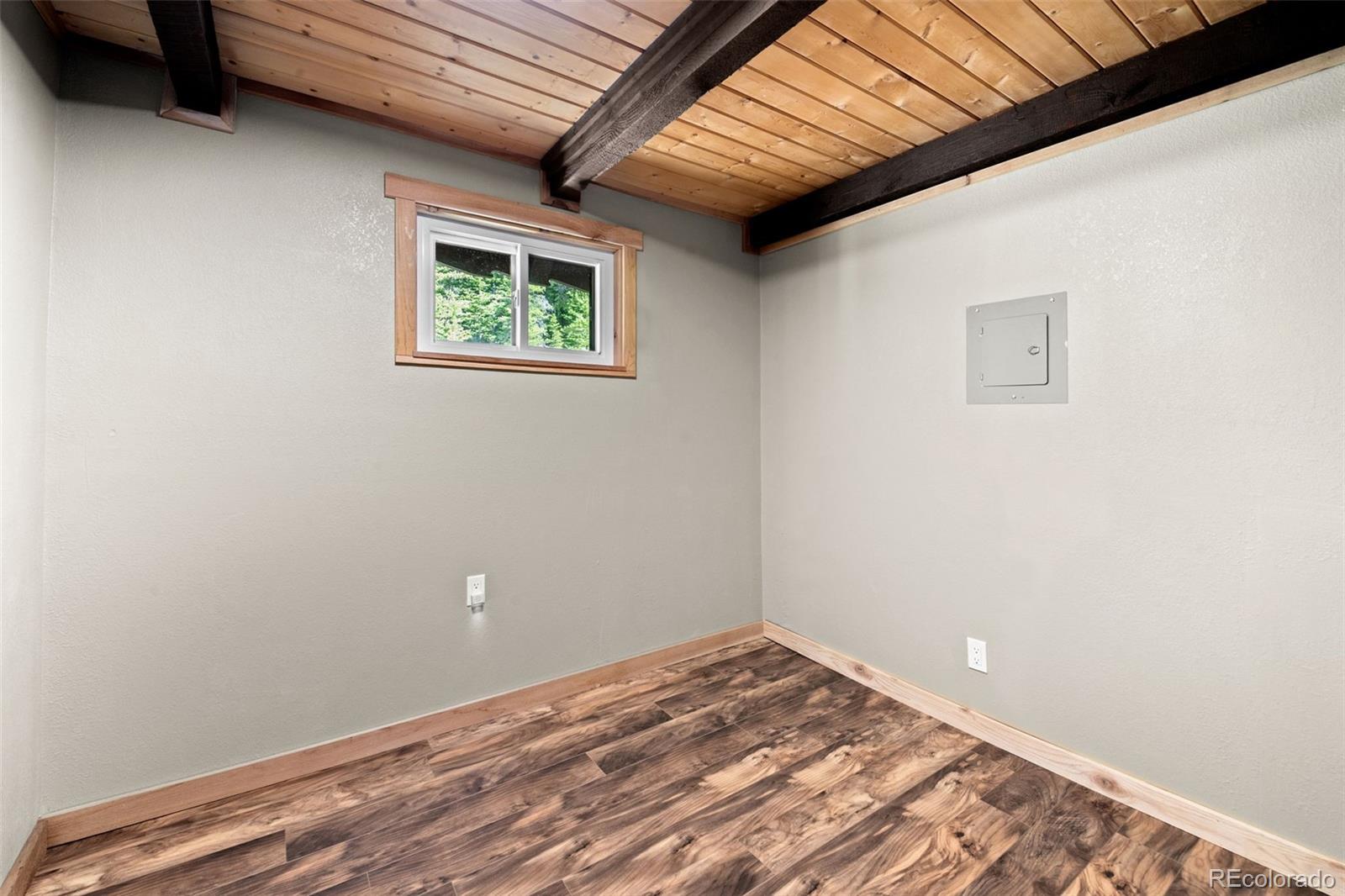 827 Mine Road Idaho Springs, CO 80452 - Photo 13 of 30 a view of a room with wooden floor and a window