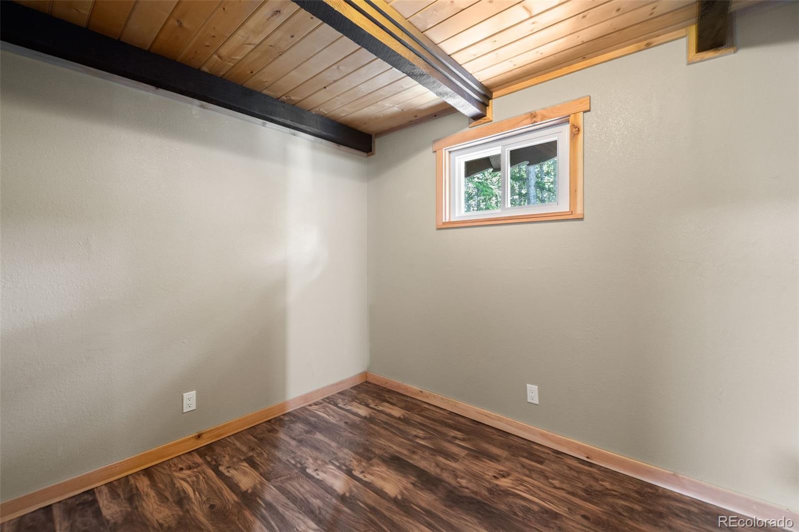 827 Mine Road Idaho Springs, CO 80452 - Photo 15 of 30 a view of a room with wooden floor and a window