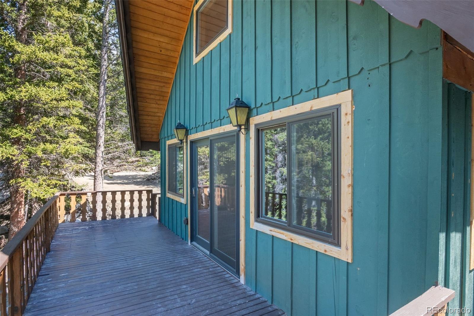 827 Mine Road Idaho Springs, CO 80452 - Photo 21 of 30 a view of a porch with wooden floor and outdoor space