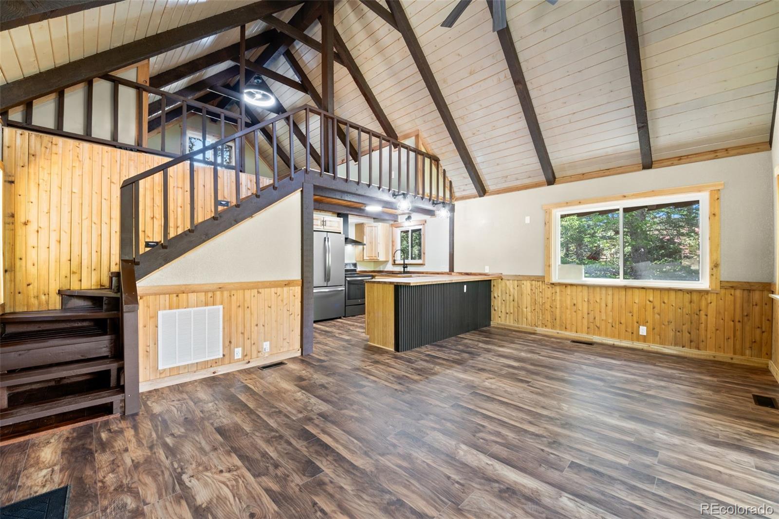 827 Mine Road Idaho Springs, CO 80452 - Photo 4 of 30 a view of an empty room with wooden floor and a window