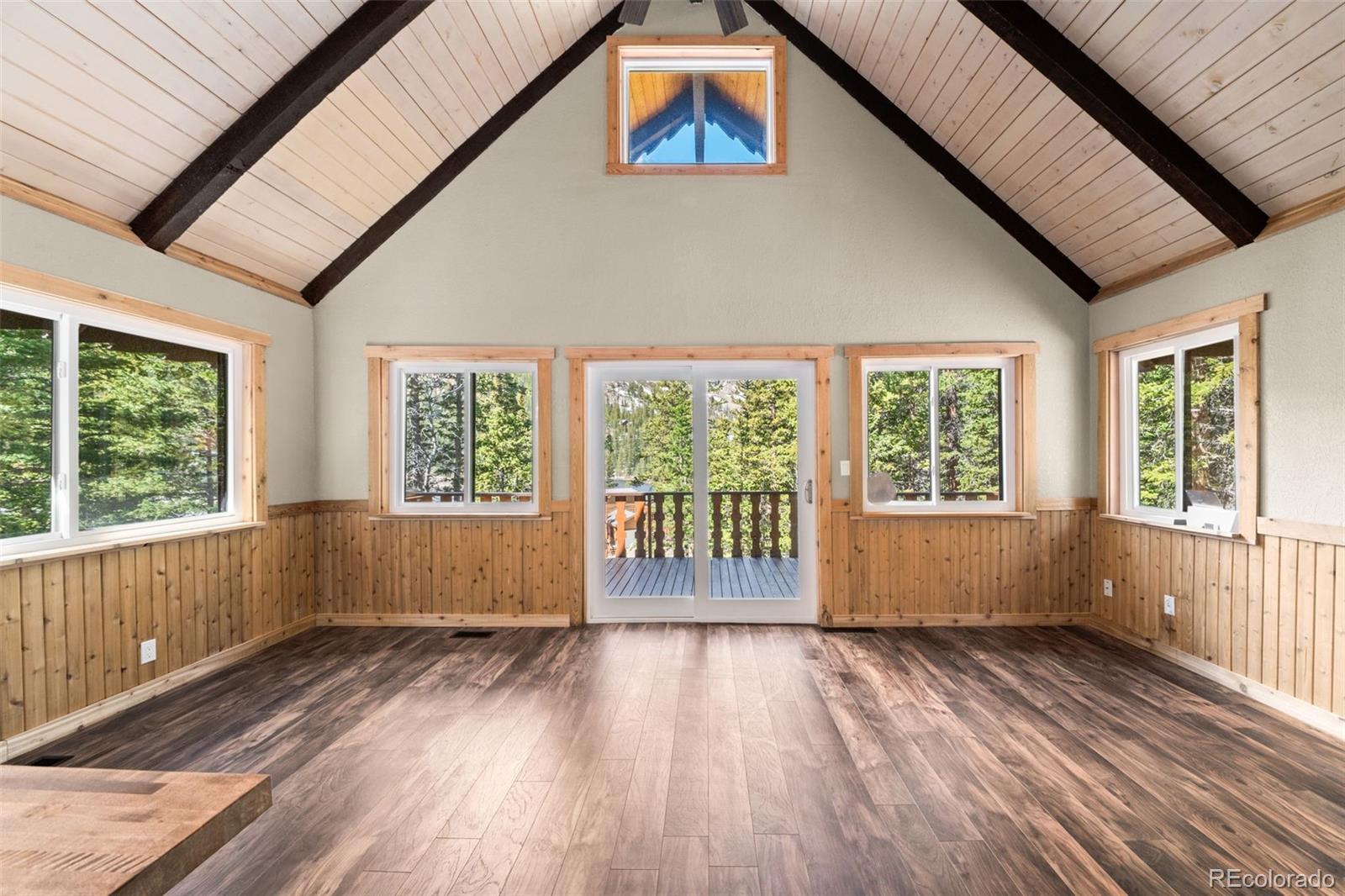 827 Mine Road Idaho Springs, CO 80452 - Photo 7 of 30 a view of an empty room with wooden floor and a window