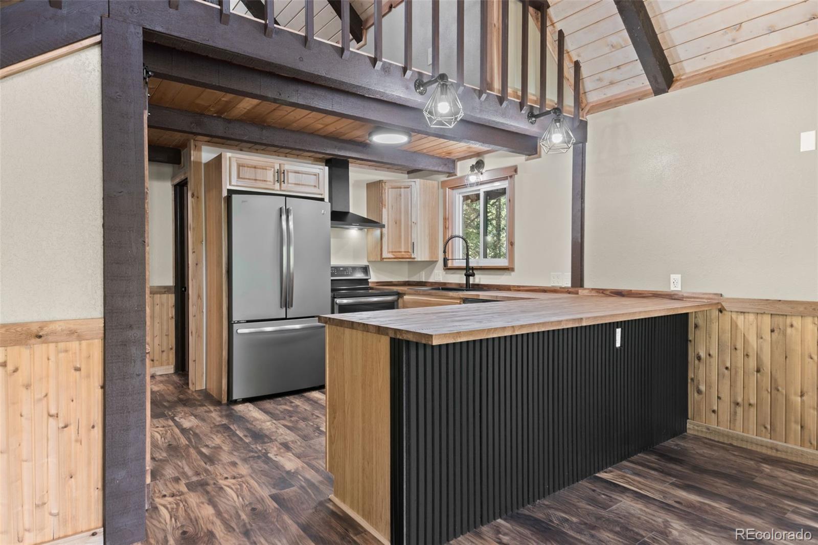 827 Mine Road Idaho Springs, CO 80452 - Photo 9 of 30 a kitchen with stainless steel appliances granite countertop a sink refrigerator and cabinets