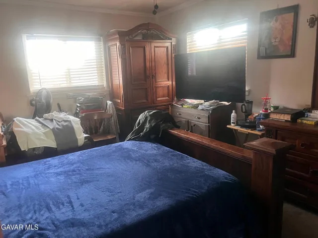 a bedroom with two beds and a window