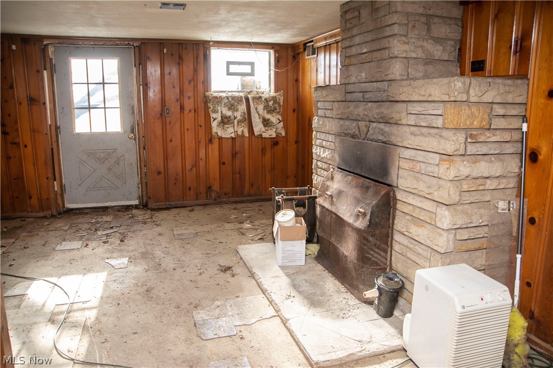 5940 Warren - Sharon Road Brookfield, OH 44403 - Photo 25 of 35 Stone woodburning fireplace in the basement walk-out area