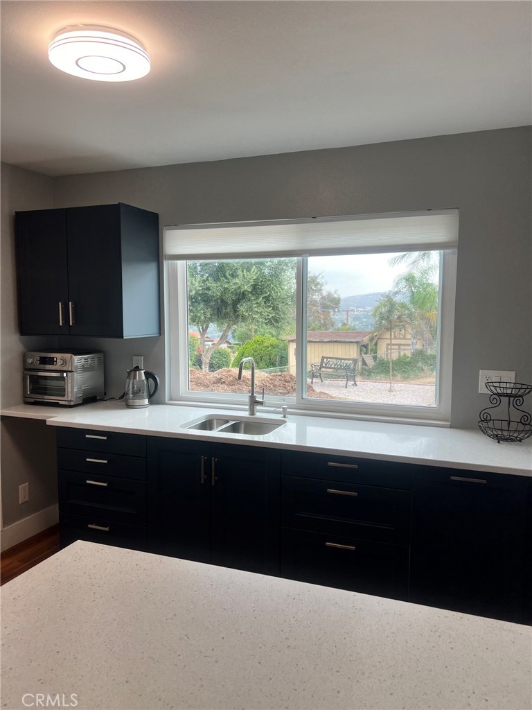 14035 Oakley Drive Riverside, CA 92503 - Photo 19 of 25 a kitchen with granite countertop a sink and a stove
