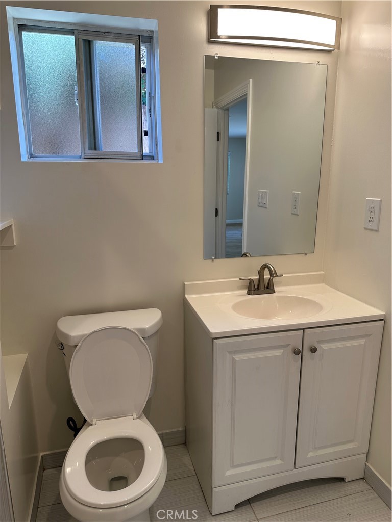 1636 West 214th Street Torrance, CA 90501 - Photo 13 of 14 a bathroom with a toilet sink and mirror