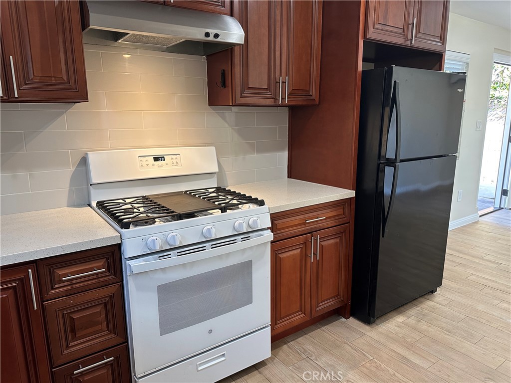 1636 West 214th Street Torrance, CA 90501 - Photo 4 of 14 a kitchen with a stove microwave and refrigerator
