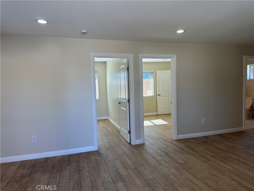 1636 West 214th Street Torrance, CA 90501 - Photo 6 of 14 wooden floor in a hall with an empty room