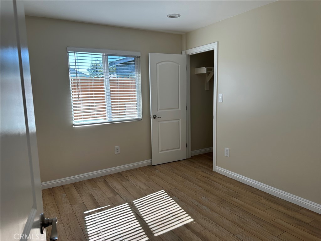 1636 West 214th Street Torrance, CA 90501 - Photo 8 of 14 a view of an empty room with wooden floor and a window