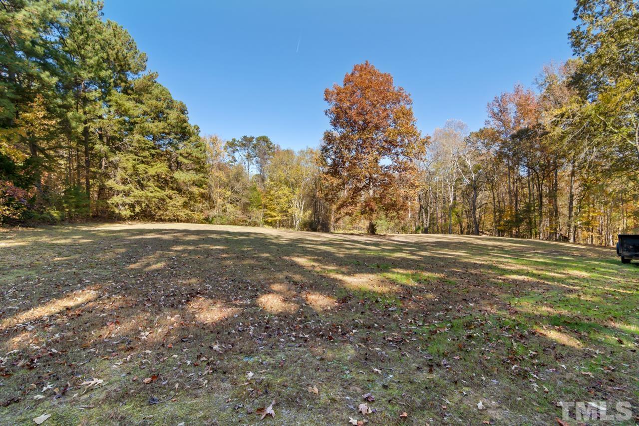1208 John Jones Road Bahama, NC 27503 - Photo 22 of 30 a view of dirt field with large trees