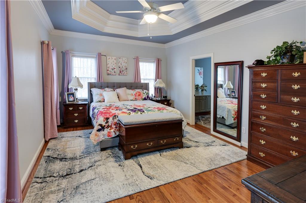 7925 Old Salisbury Road Linwood, NC 27299 - Photo 14 of 31 Master bedroom with tray ceiling that connects to an en-suite bathroom & walk in closet