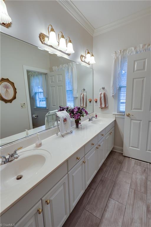 7925 Old Salisbury Road Linwood, NC 27299 - Photo 17 of 31 Master bathroom with double sinks on one side and a single sink on the other