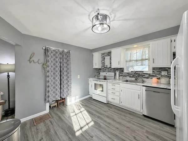 a kitchen with cabinets a sink and appliances