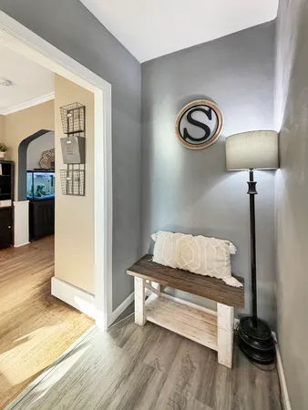 a bedroom with a bed and lamp on desk