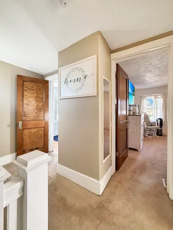 a view of a kitchen with fridge and wooden floor
