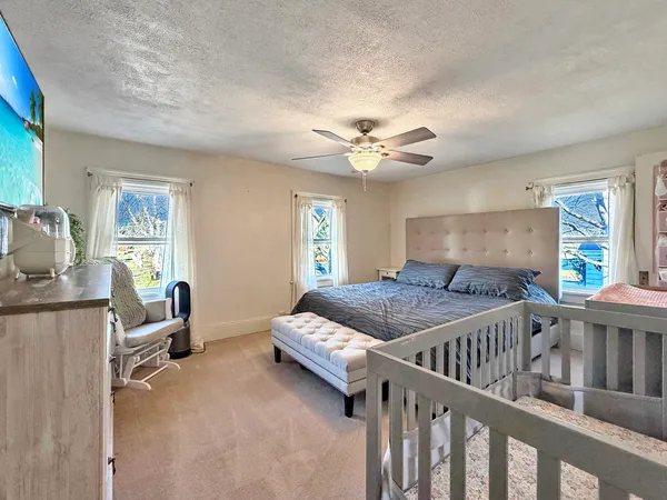 a bedroom with furniture and a window