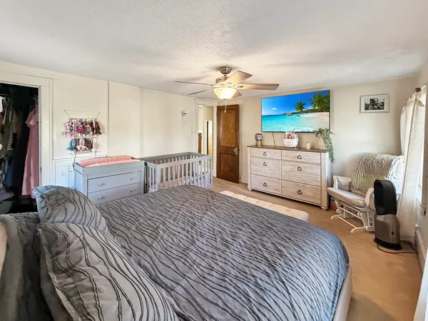 a bedroom with furniture and a flat screen tv
