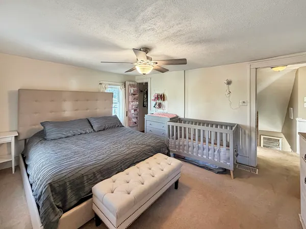 a bedroom with a bed and a chandelier