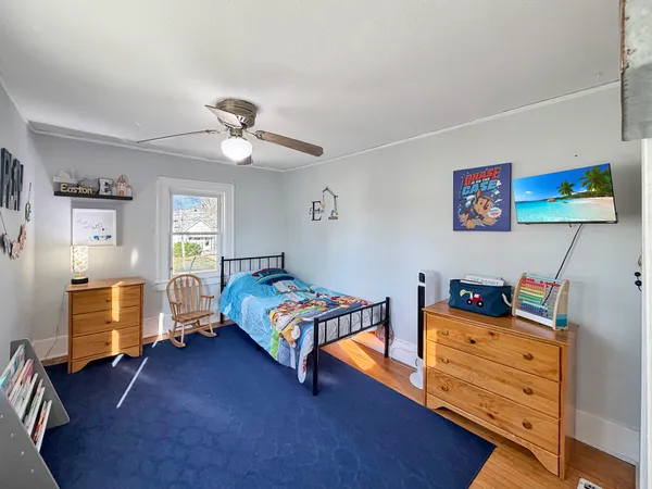 a bedroom with furniture and a flat screen tv
