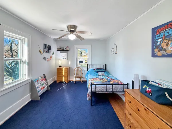 a bedroom with furniture and a wooden floor
