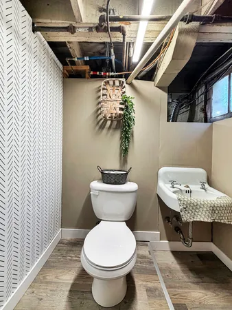 a bathroom with a toilet and a mirror