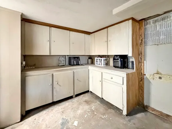 a kitchen with cabinets oven a sink and dishwasher with kitchen island