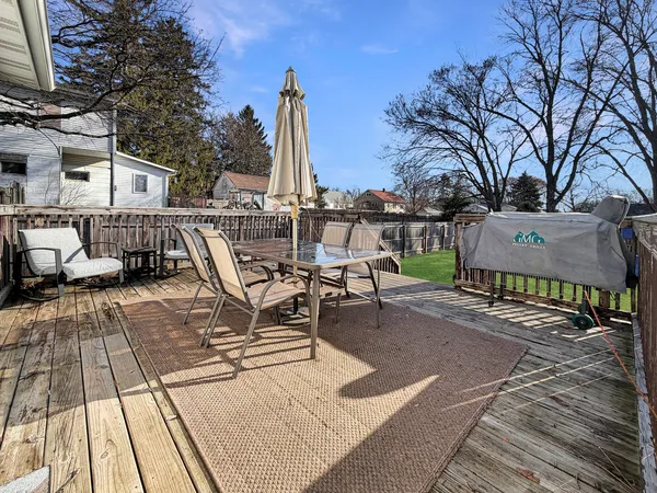 a view of a patio with chairs and wooden floor