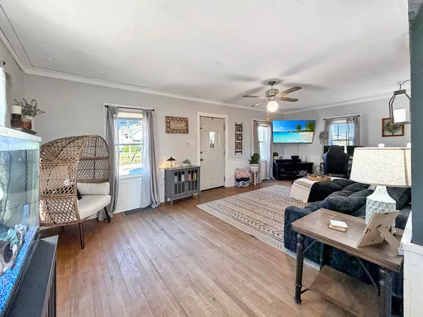 a living room with furniture and a wooden floor
