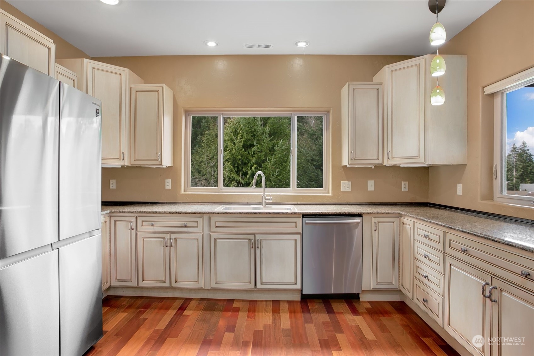 943 Summit Lake Shore Road Northwest Olympia, WA 98502 - Photo 9 of 40 a kitchen with stainless steel appliances granite countertop a stove a sink and a refrigerator