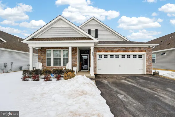 a front view of a house with a sitting area