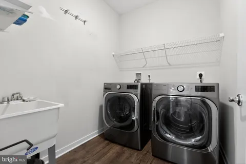 a utility room with sink dryer and washer