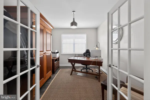 a living room with furniture a rug and a window