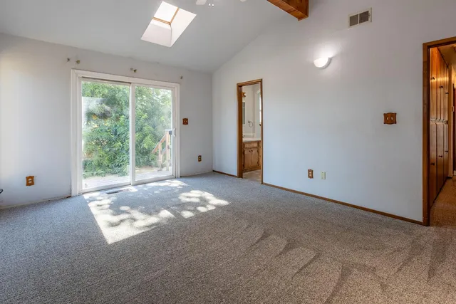 a view of a livingroom with a ceiling fan and window
