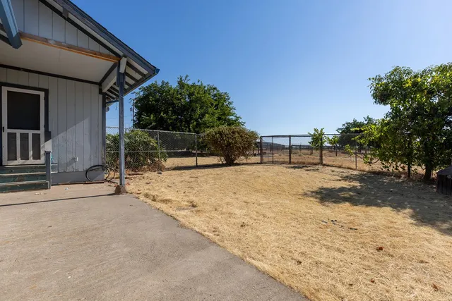 a view of backyard with large trees