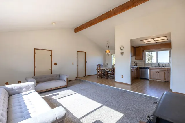 a living room with furniture and a view of bathroom